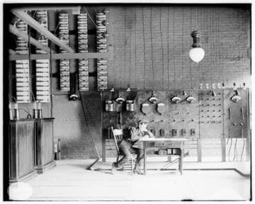 An operator sitting at a desk in front of the switchboard at the Pomona Substation