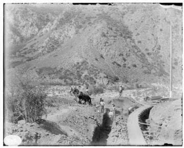 A construction crew with their horses at the excavation of the tailrace at Mill Creek #3 Hydro Plant