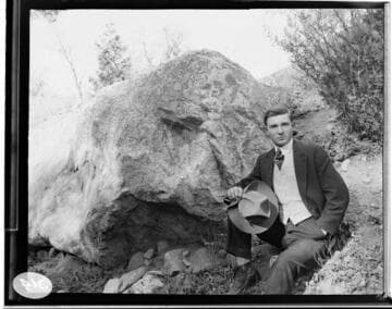Man leaning up against the rocks