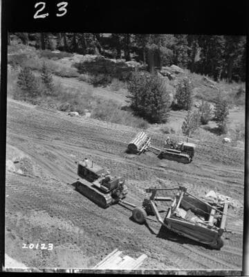Carryall and sheepsfoot working on backfill at east end Dam 1