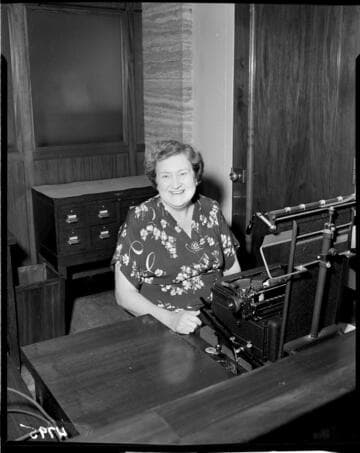 Typist sitting at typewriter