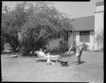 Family barbecuing in backyard