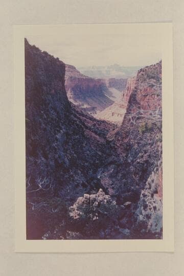 On the Old Trail just above the descent into the wash below the Redwall.  The small pinnacle in the sun near the bottom of the print is a cairn which appears in older photos