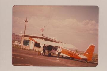 Ron Smith's plane at Kanab Airport.  Art Gallenson at left; John Hoffman at right
