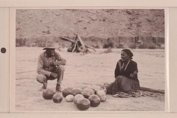 Hyde and Indian squaw, both smiling.  Camp at mouth of Piute.  USGS San Juan survey