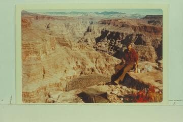 Uinkaret Mountains from south rim of Spring Canyon.  Jorgen Visbak samples lunch