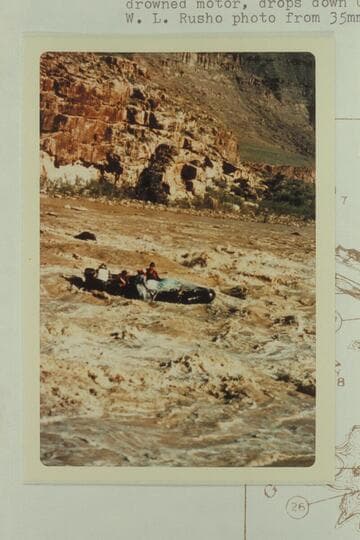 George Stewart's 10-man, half full of water and with a drowned motor, drops down Coal Creek Rapid