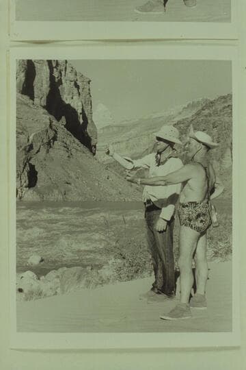 Hudson and Marston pose for the photographer to illustrate the business of studying a rapid before running it; Hance Rapid