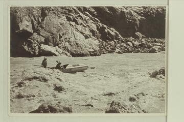 Del Reed at the oars and Bill Gibson riding at the foot of Grapevine Rapid.  Nevills party of 1938.  Bright Angel gauge:  19,800 cfs