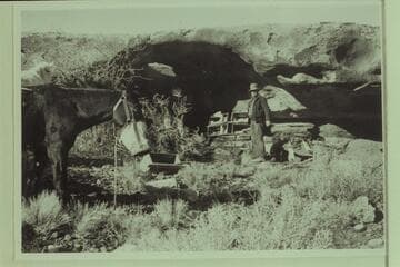 In camp.  Opening in back of cave appears to establish a small arch