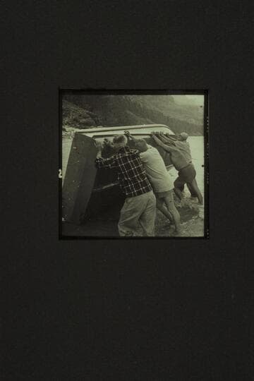 The "Rattlesnake" had a case of water on the bilge so she was rolled up at Tapeats Creek.  A hole had been sliced in her bottom amidships by a rock in Bedrock Rapid.  Left to right:  Eisaman, Taylor, Belknap and Sanderson