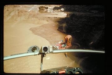 Bill Belknap pulls out cameras as chopper takes off