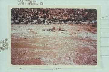 Jean and Hal Bennett run out of lower end of Rapid #22.  Note round-topped boulder upper right.  10,430 cfs