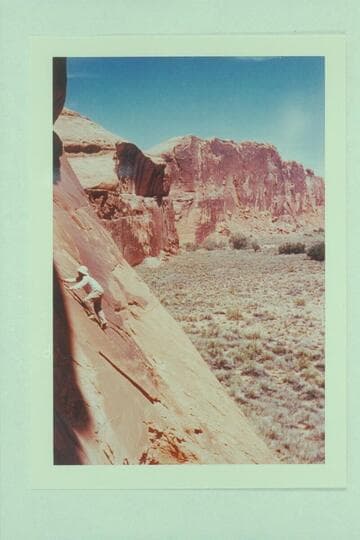 Harry Aleson climbing Moki steps on right bank of Glen Canyon at Smith Fork Bar