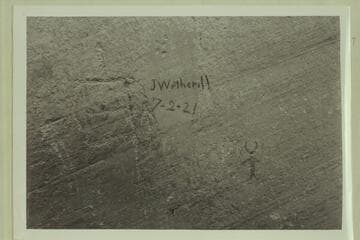 John Wetherill inscription.  Mile 50.4 in Glen Canyon.  In charcoal on petroglyph cliff