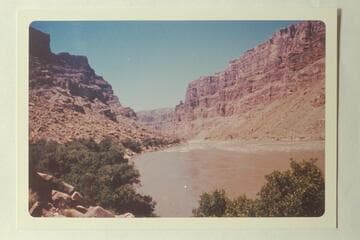 Down from approximately Mile 204.85 at head of One Mile Rapid from below a point opposite the mouth of Range Canyon.  The button showing against the sky on right bank is at Mile 203