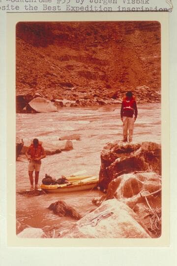 Dock Marston watches Buzz Belknap line rapid at Mile 204.55.  Opposite the Best Expedition inscriptions