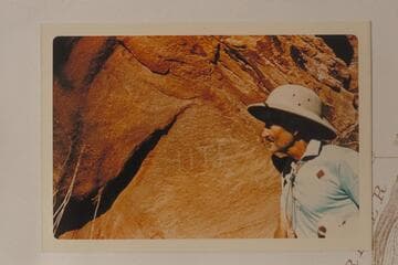 Hite inscription at small side canyon below lower end of Good Hope Bar, Mile 143.9.  Harry Aleson examines it while Pete Sparkes makes the photo
