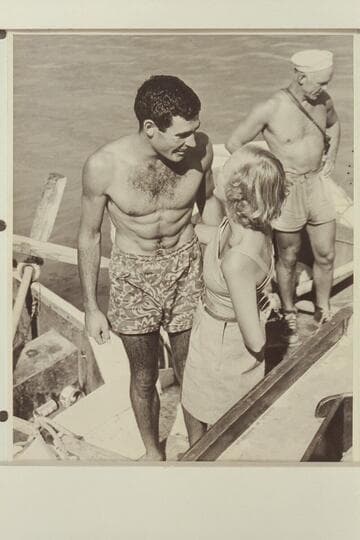 Garth Marston is greeted by Shirley at the head of Lake Mead; end of 1948 traverse of the Grand Canyon.  Moulty Fulmer is at right