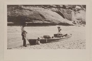 Skiff of Lasky party in small rapid just below Hite;  Jesse Lasky, Jr. and Kenneth Wortley