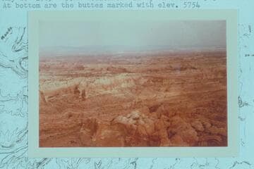 Westerly across Stevens Canyon from approximately two miles below the Garfield and Kane Counties boudary.  At bottom are the buttes marked with elevation 5754