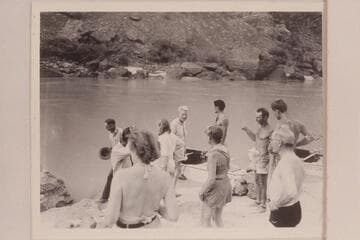 On beach on right bank at head of Lava Falls:  John Riffey; Kent Frost; Marie Saalfrank; Zoe Desloge; Margaret Marston; Garth Marston; Norm Nevills; Joe Desloge; Randall Henderson with black trunks