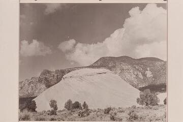Small sandstone butte and Navajo Mountain