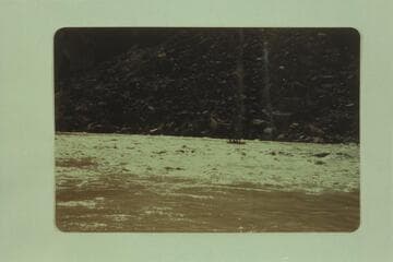 The "Esmeralda" pulling into the current at the lower end of Badger Rapid after picking up two member of the crew from the beach at the right