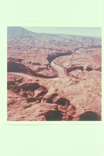 Down Glen Canyon from over Cottonwood Creek.  Hidden Passage enters from right.  Music Temple is just below and opposite.  Anasazi Canyon enters from left above center.  Navajo Mountain and Butte 6069 are upper left.  Butte 5014 upper center