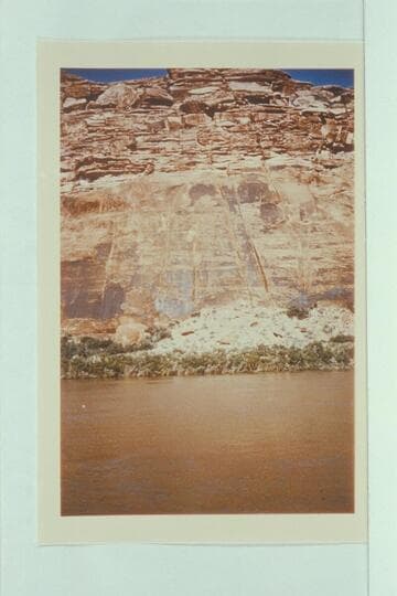"Pumpkin Rock," left bank, two miles north of San Juan River.  Pumpkin located at top of talus, just below smooth wall face.  Letter of Edward T. Vetter, 1957, Dec. 23