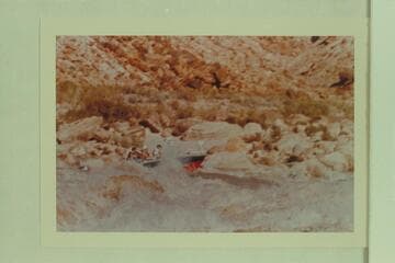The "Bootoo" in Badger Creek Rapid.  Left to right:  Buzz Belknap, Dock Marston and Vee Bodrero