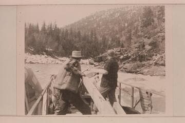 The sweep-scow threads among the rocks of the Salmon River, Idaho.  Carl Kriley and Don Smith at the sweeps