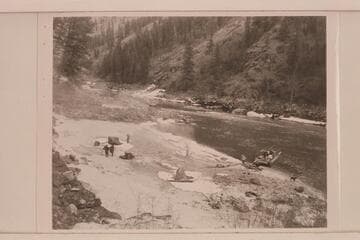 Camp on the icy beach.  The tent being rigged on the scow.  The sweeps are put ashore