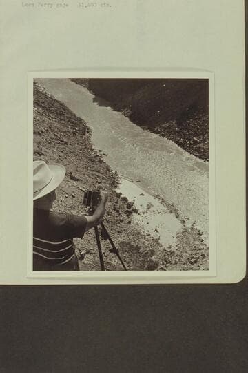 Marston on the rim photographing the Wright and Rigg boats beached at the foot of Badger Creek Rapid
