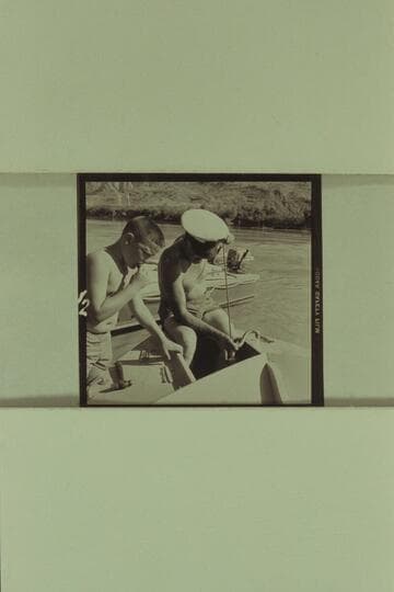 Buzzy Belknap watches Sanderson bail the forward hatch of one of the boats at Lees Ferry