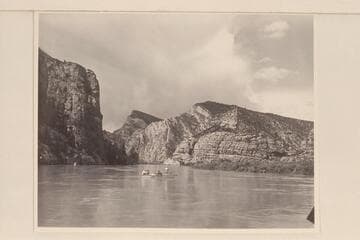 Nevills at the oars of the "Wen" at the foot of Kingfisher Canyon.  Al Milotte stands in the bow