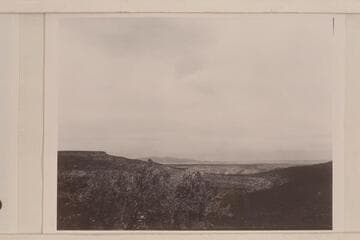 View into Mule Canyon from escarpment on the Shivwits Plateau.  The table land on the left is the end of Grassy Mountain.  In the distance, center is Mt. Emma.  The Grand Canyon is to the right and out of the picture