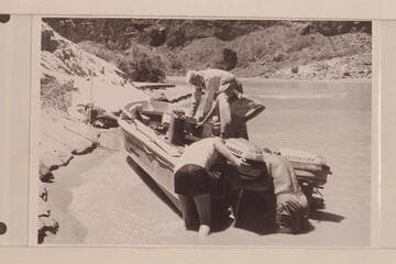 Hanging the spare motor on the "Rattlesnake" after the capsize in Vulcan Rapid.  Desloge and Atherton are in the boat, Beer and Sanderson are at the stern