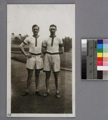 Edwin Powell Hubble and William Ziegler in track team uniforms, standing on a running track