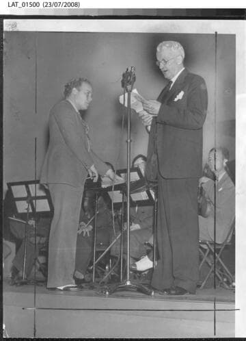 Raymond Paige and Harry Chandler on stage for a CBS radio broadcast