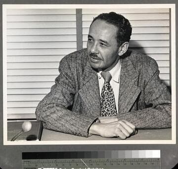 Loren Miller, seated at desk