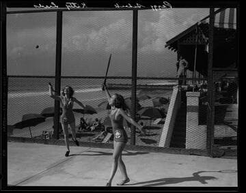 Peggy Scheck and Kitty Leeds playing tennis at the Sea Breeze Beach Club, Santa Monica