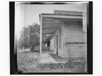 Row of unidentified small wooden houses or cabins