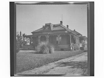 Unidentified brick house with wrap-around porch