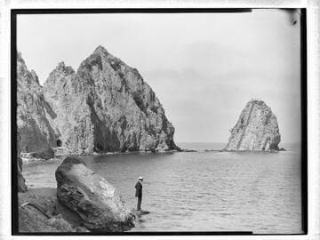Man on rocks and Sugar Loaf Rock in the background, Catalina Island