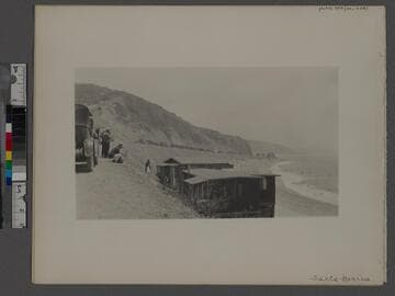 Santa Monica Bay beach with cars and people
