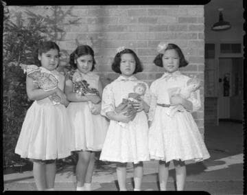 Little girls holding Christmas dolls