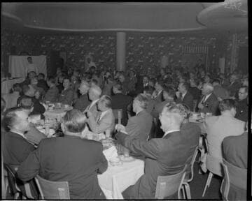 People at tables during speeches