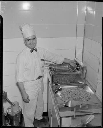 Man mixing nuts in kitchen