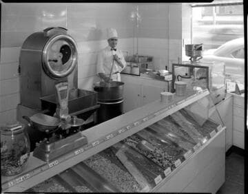 Man roasting nuts behind counter